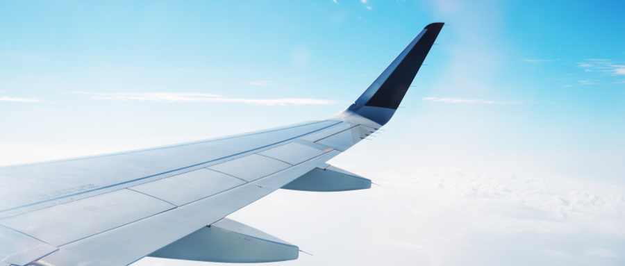 Airplane wing above clouds